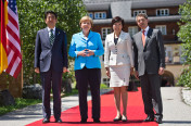 German Chancellor Angela Merkel and her husband Joachim Sauer (right) welcome the Japanese Prime Minister, Shinzo Abe, and his wife Akie (2nd from right) in front of Schloss Elmau