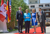 German Chancellor Angela Merkel and her husband Joachim Sauer (right) welcome the Canadian Prime Minister, Stephen Harper, and his wife Laureen (2nd from right) in front of Schloss Elmau