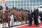 French President François Hollande is greeted at Munich airport on 7 June 2015 by Bavarian Minister-President Horst Seehofer and a group of "Gebirgsschützen"