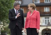 German Chancellor Angela Merkel welcomes Guy Ryder, Director-General of the International Labour Organization (ILO), in front of Schloss Elmau