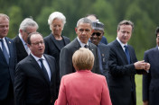 Tusk (European Council), Juncker (European Commission), Hollande (France), Lagarde (IMF), Obama (USA), Buhari (Nigeria) und Cameron (UK) (from left to right) stand in front of Federal Chancellor Angela Merkel before the family photo is taken