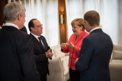 Canada’s Prime Minister Stephen Harper, France’s President François Hollande, German Chancellor Angela Merkel and the President of the European Council, Donald Tusk, talking before the beginning of the third G7 working session