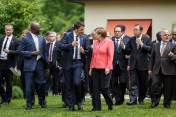 Chancellor Angela Merkel talks with Italian Prime Minister Matteo Renzi on the way to the G7 Outreach group photo