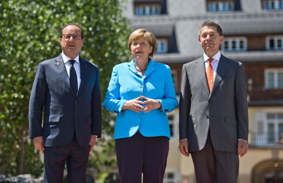 Chancellor Angela Merkel and her husband Joachim Sauer (right) welcome France’s President François Hollande in front of Schloss Elmau