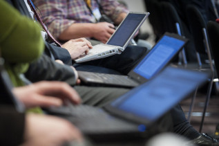 Journalists working on their laptops at an EU press conference